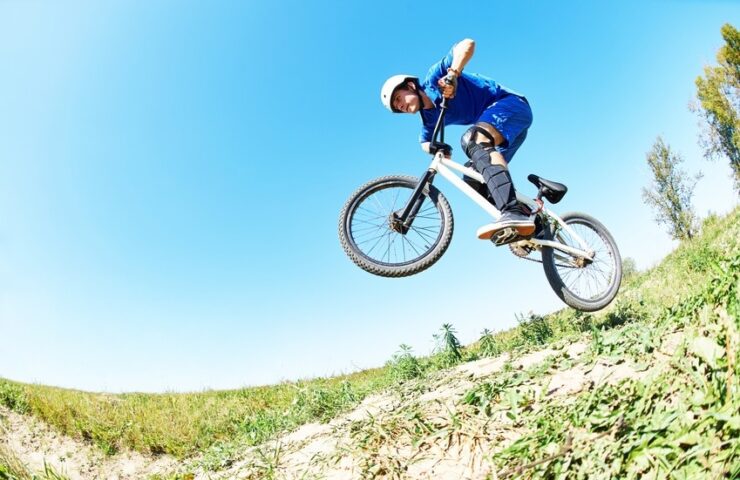 cyclist riding jumping with bicycle cross-country