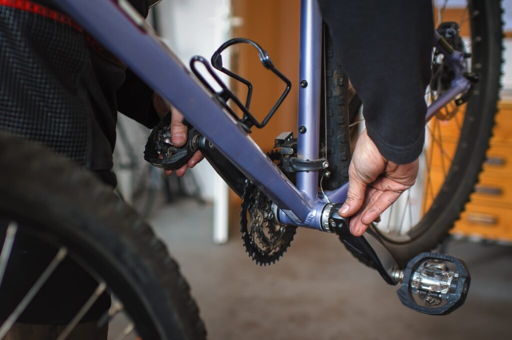 mechanic inspecting bike bottom bracket 