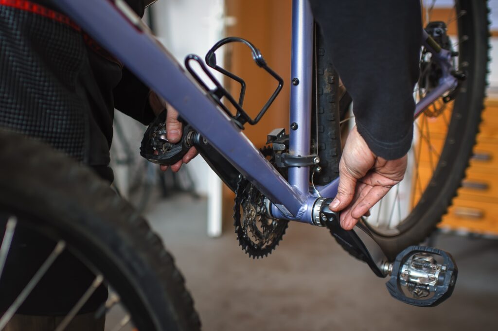 mechanic inspecting bike bottom bracket