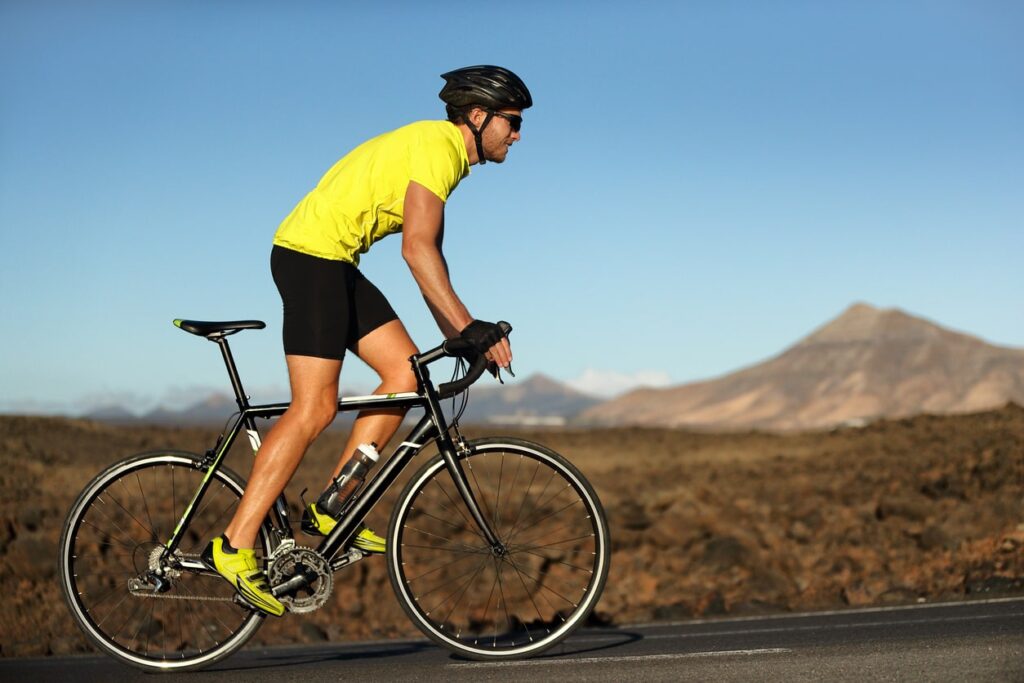 cyclist in yellow shirt using ntn bearings in bike