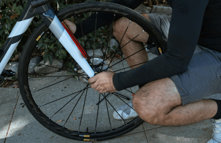 Bike rider adjusting front bike wheel